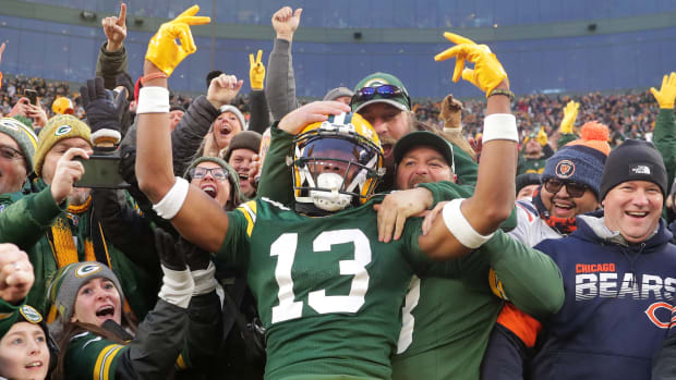 Green Bay Packers wide receiver Dontayvion Wicks (13) reacts after catching a touchdown pass against the Chicago Bears during the first half at Lambeau Field.